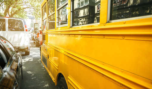 Yellow school bus parked on the street of New York City