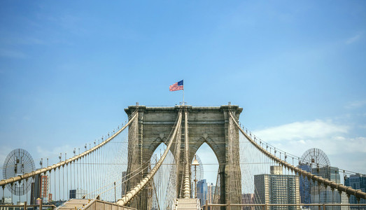 Brooklyn Bridge towers with Manhattan skyline on background