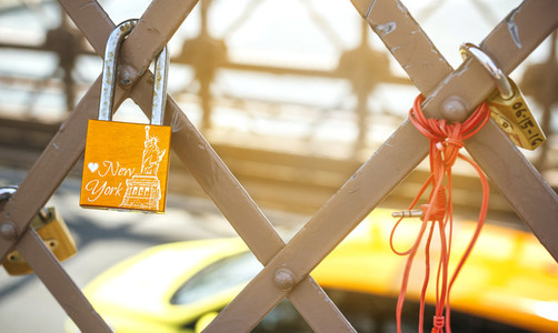 Love lock with Statue of Liberty and yellow cab on background