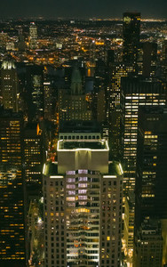Skyscrapers windows illuminated at night in Manhattan
