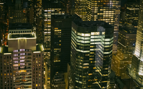 Skyscrapers windows illuminated at night in Manhattan