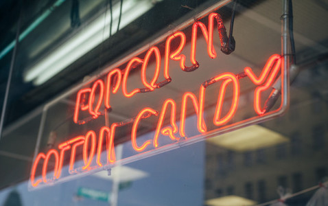 Red neon sign with words Popcorn Cotton Candy