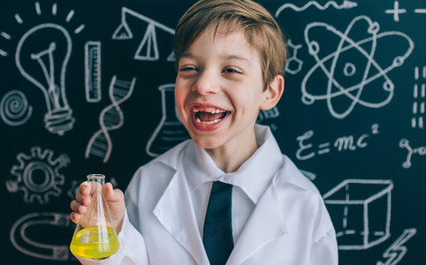 Happy kid laughing and showing liquid in flask