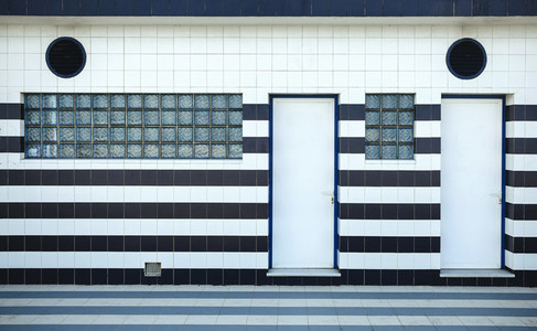 Blue and white tiled facade with glass blocks