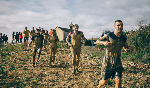 Participants in a extreme obstacle race running