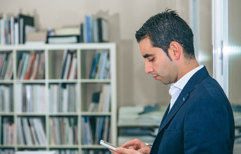 Businessman looking his smartphone in the office