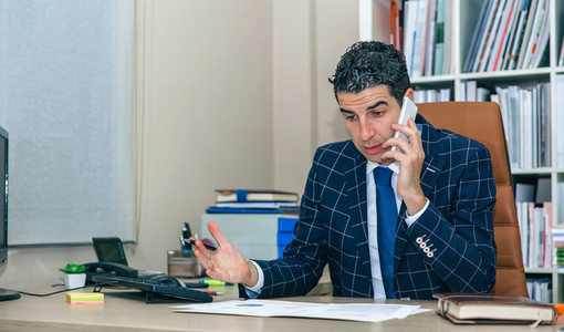 Businessman having discussion by phone in office