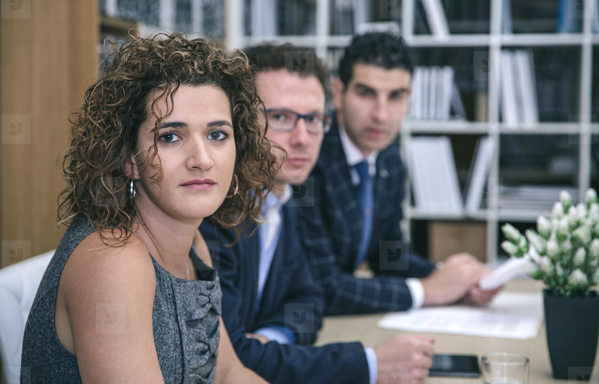 Executive chief sitting at negotiating table with team