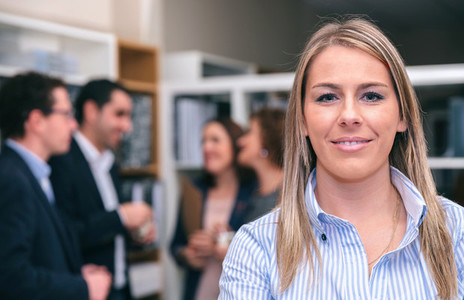 Portrait of blonde woman looking at camera in office