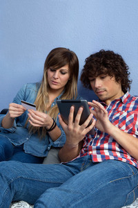 Couple making online purchase with tablet