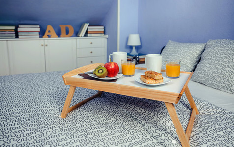 Bed tray with breakfast for two on bed
