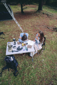 Young women having breakfast in a campsite