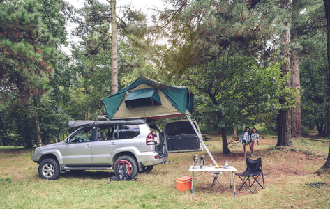 Camping table and off road vehicle in campsite