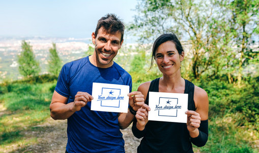 Man and woman showing their trail race number