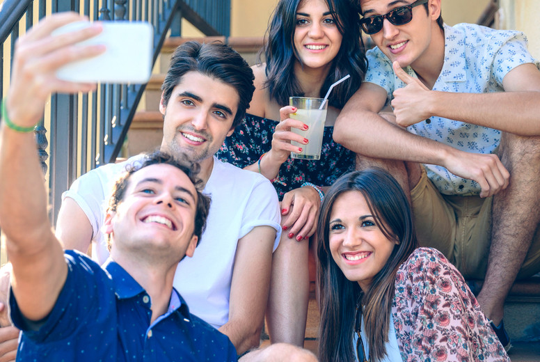 Young happy people taking a selfie with smartphone