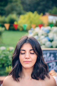 Portrait of woman with closed eyes in garden