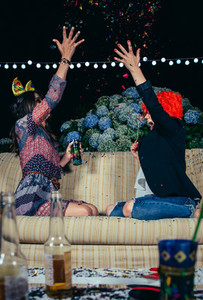 Happy women throwing confetti to the air in party