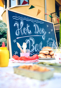 Blackboard over table with food and drinks in party