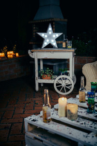 White star lamp with light bulbs over wooden cart