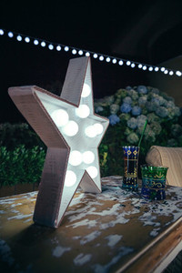 White star lamp with light bulbs over table