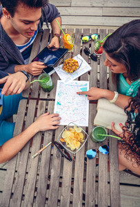 Young friends looking map over a table