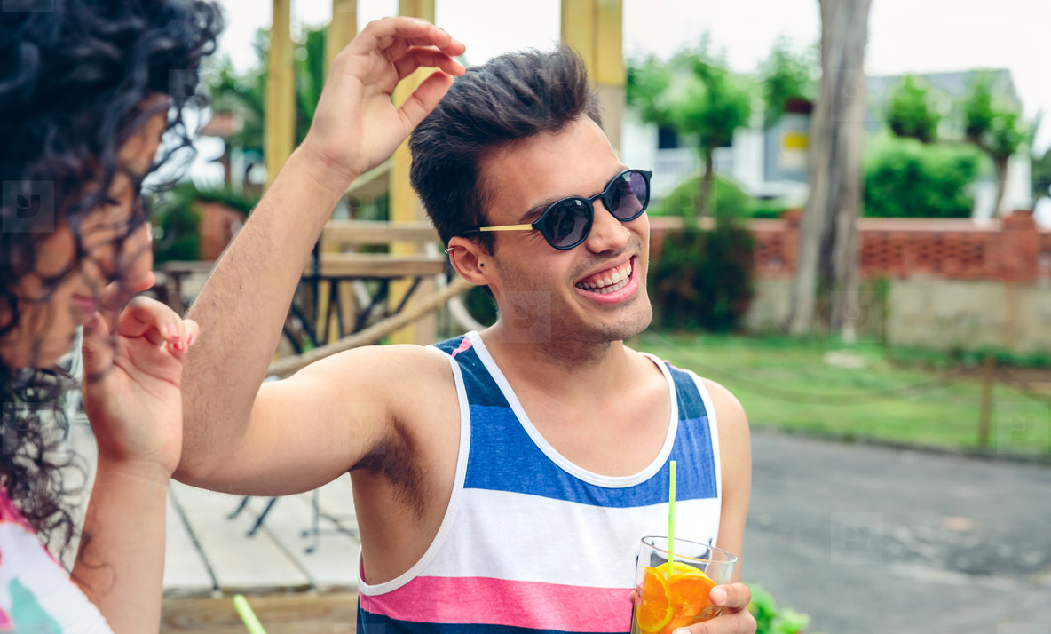 Happy man with sunglasses laughing in summer party