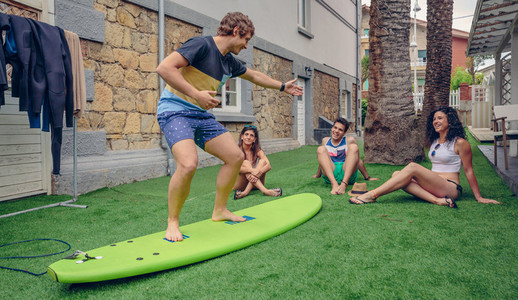 Group of people having fun in a surf class