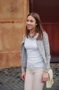 Fashion portrait of young trendy woman walking outdoors
