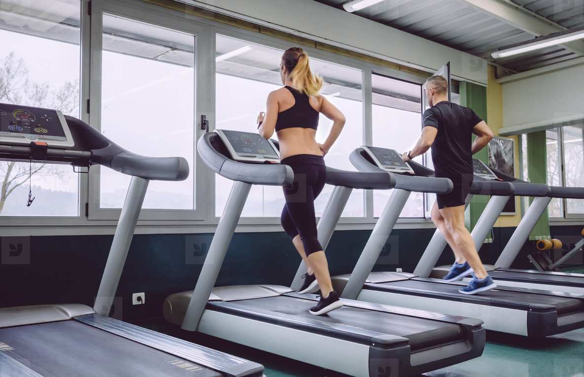 People running over treadmill in a training session