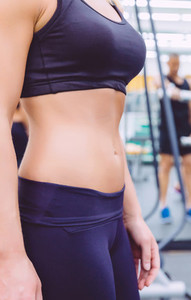 Slim waist closeup of sporty woman with black sportswear