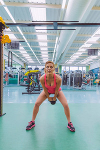 Woman lifting kettlebell in crossfit training