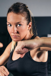 Woman training hard boxing in the gym