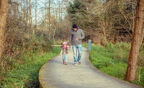 Father and daughter walking together holding hands