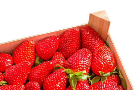 Box corner of strawberries isolated on white background