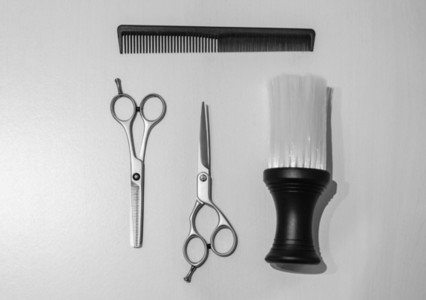 Hairdressing equipment over a white wooden background