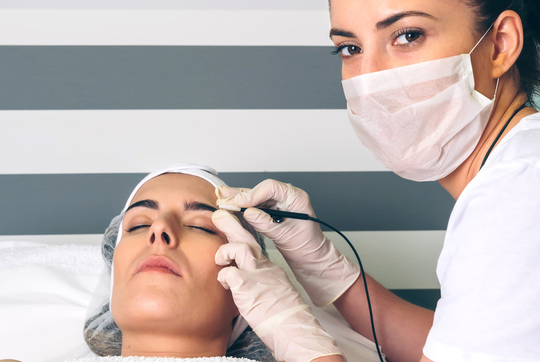 Female doctor doing getting rf lifting to woman in clinic