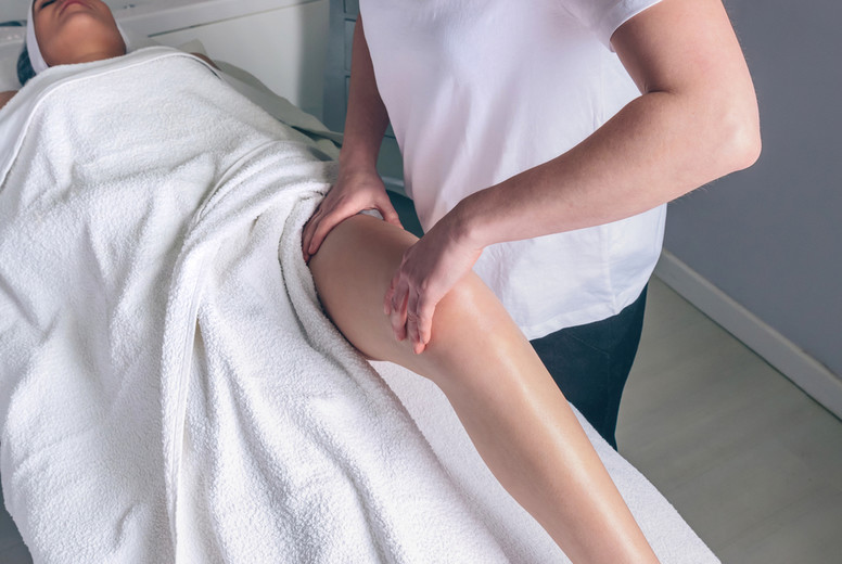 Massage therapist doing lymphatic drainage treatment to woman