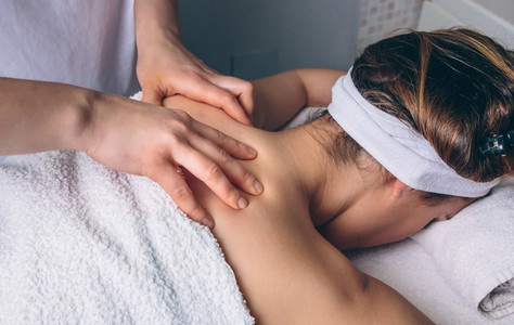 Woman receiving relaxing back massage on clinical center