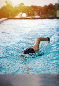 Young girl swimming freestyle