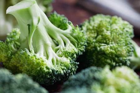 Close up of a fresh broccoli on a cutting board The concept of vegetarian and healthy food