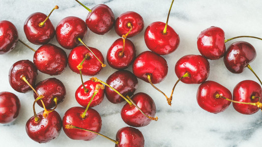 Ripe cherry on a white marble The concept of healthy organic food