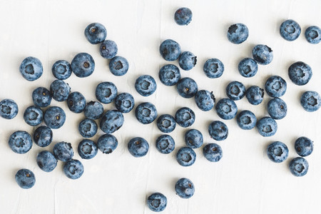 Fresh ripe blueberries over white marble  Food background  The concept of healthy eating and lifestyle