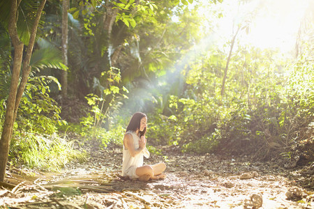 Serene woman meditating in sunny