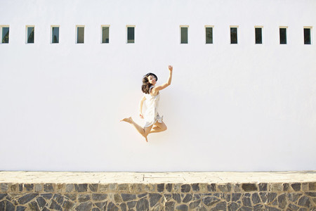 Portrait happy  carefree woman jumping