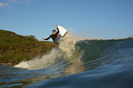 Male surfer riding ocean wave