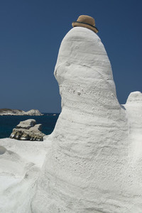 Hat perched on white rock formation  Milos  Greece