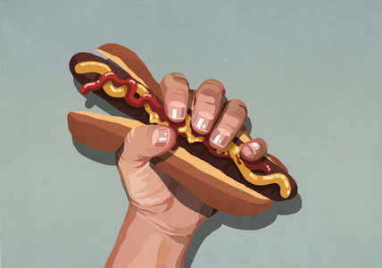 Mans hand squeezing hot dog