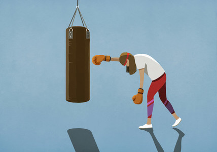 Tired woman boxing at punching bag