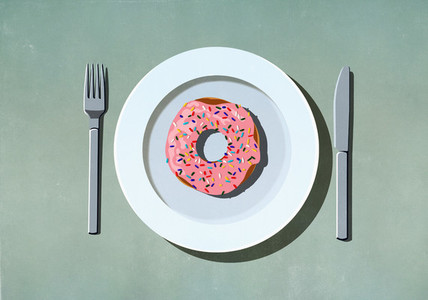 Pink donut with sprinkles on plate