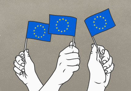 Hands waving small European Union flags